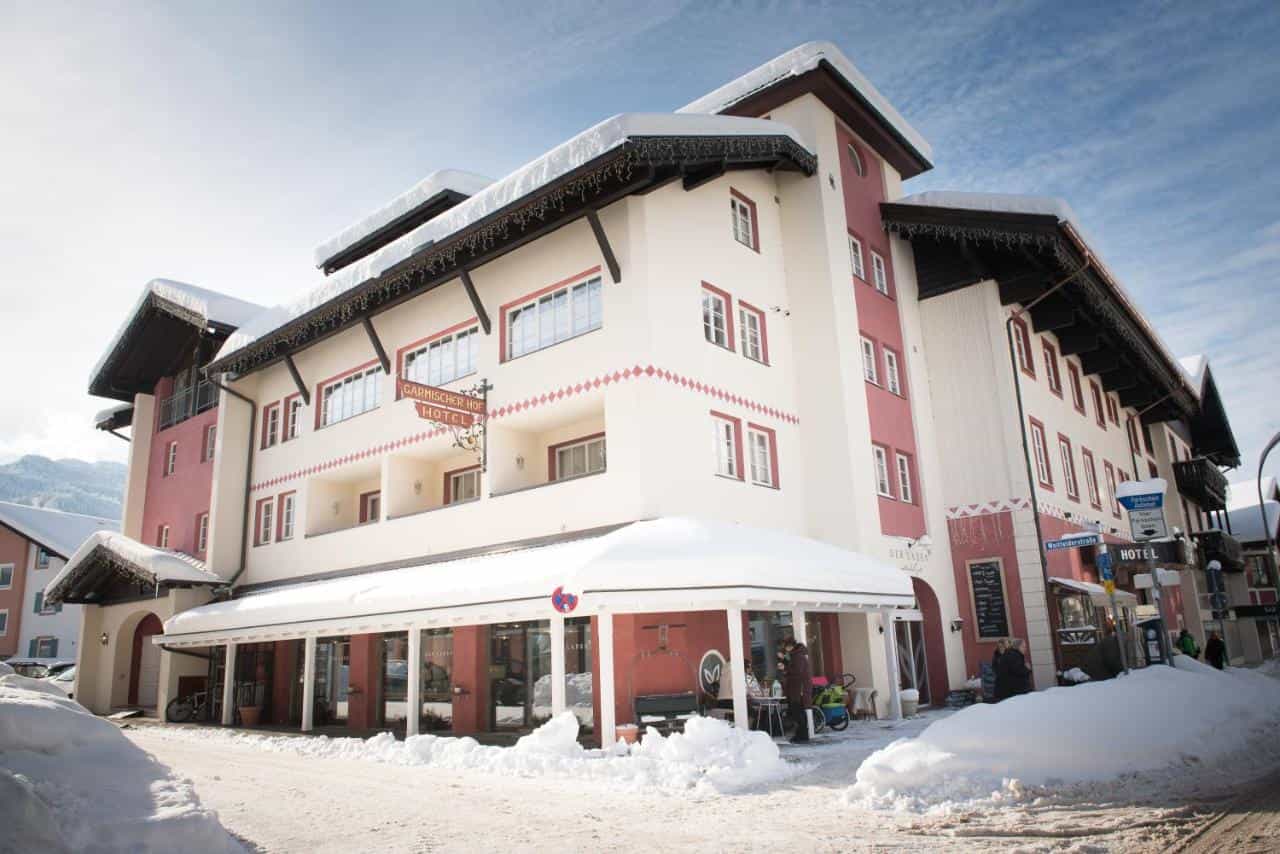 Biohotel Garmischer Hof hotel building covered in snow in an alpine village setting