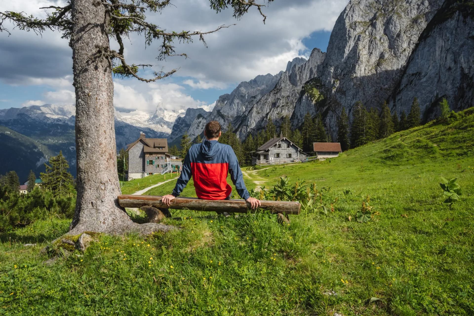 Man traveler resting on hiking trail in Gosau, Salzkammergut, Austria, Europe