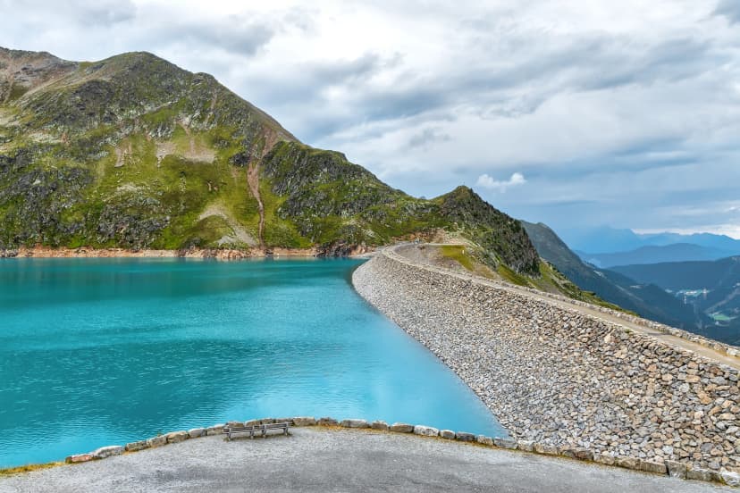 Finstertaler reservoir in Austrian Alps mountains with blue water and beautiful mountains all around it