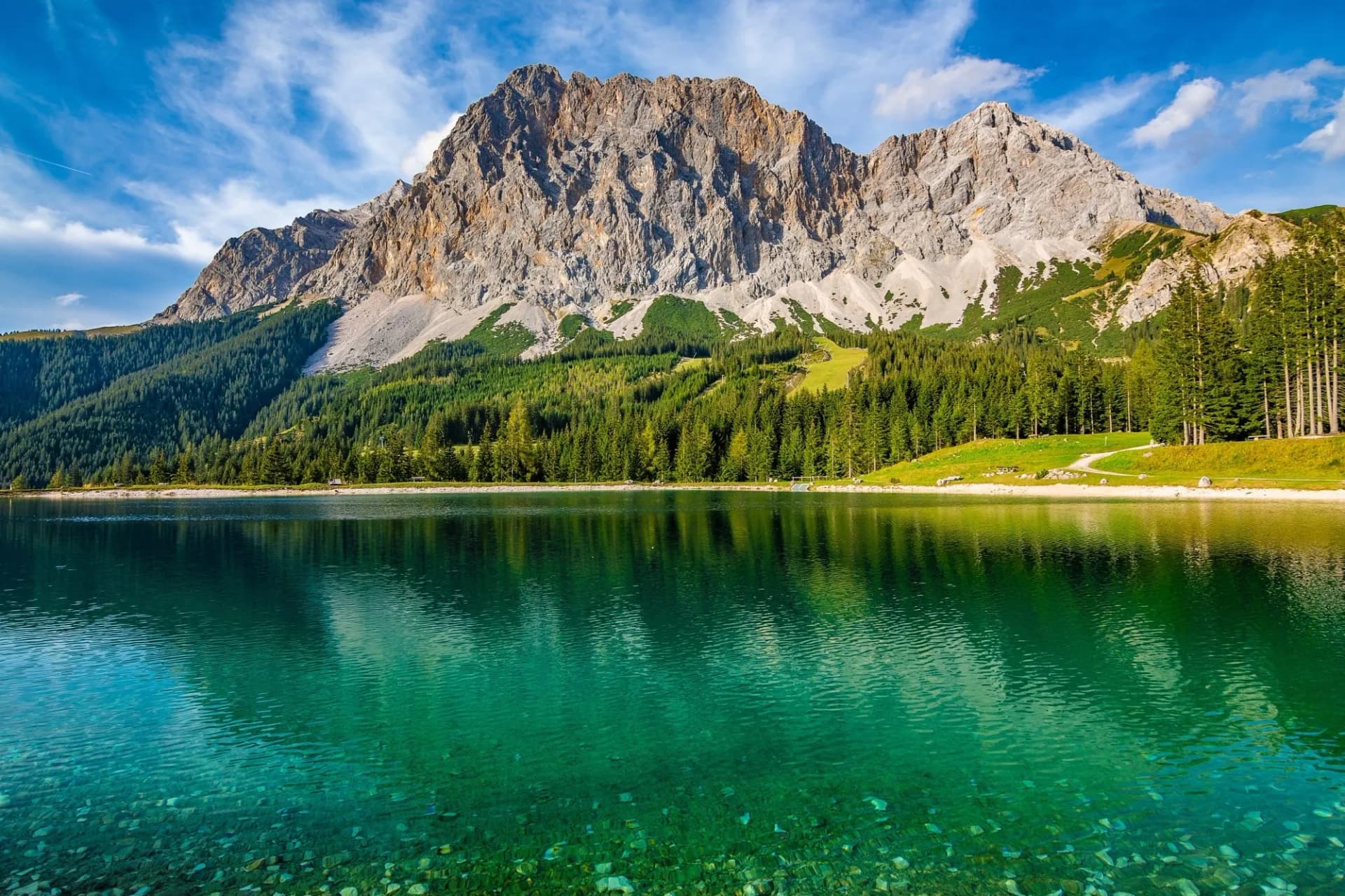 A beautiful view on the Ehrwalder Almsee and the Zugspitze on a sunny summer day in Austria, September 2018